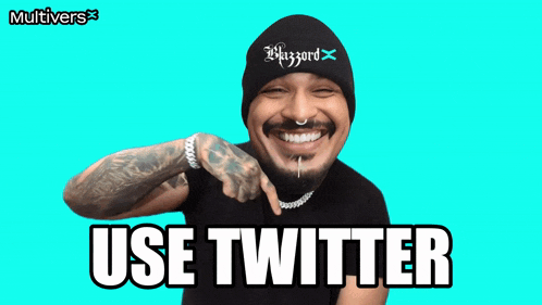 a man wearing a beanie with the word blizzard on it smiles and says " use twitter "