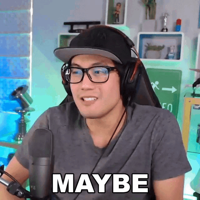 a man wearing headphones and glasses is saying maybe