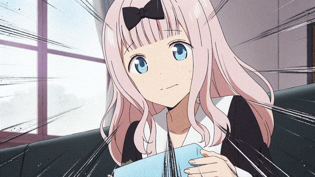 a girl with pink hair and blue eyes is sitting on a couch