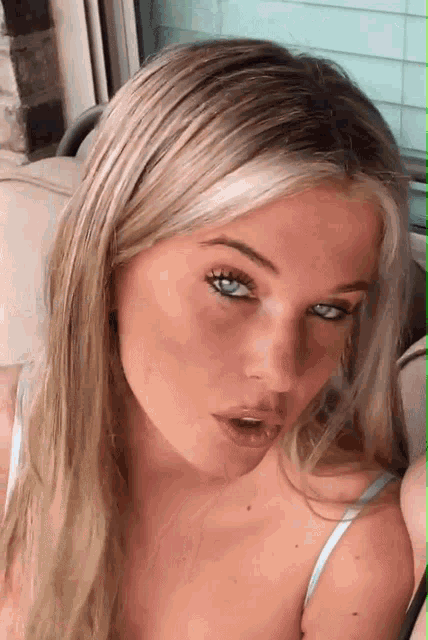 a close up of a woman 's face with blue eyes