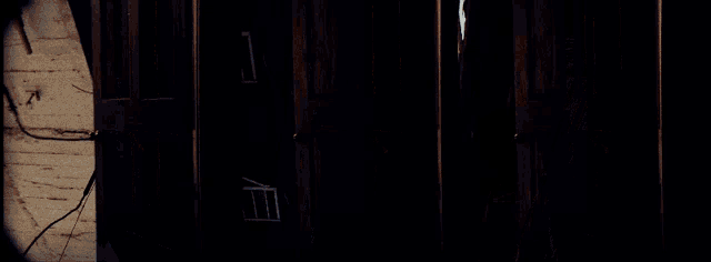a fire escape is visible between two buildings at night