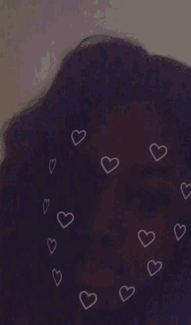 a purple background with pink hearts around a person 's head