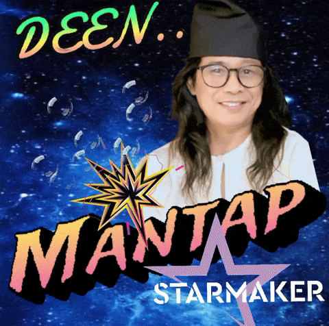a man wearing glasses and a black hat stands in front of a sign that says mantastarmaker