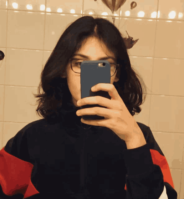 a woman taking a selfie with her phone
