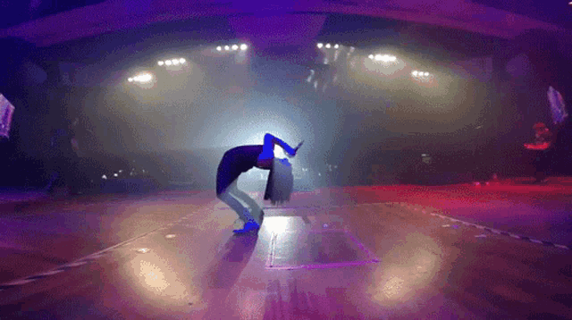 a person is doing a handstand on a stage