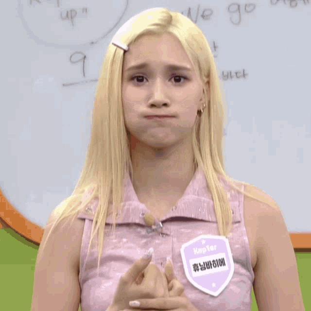 a girl with blonde hair has a name tag that says kepter on it