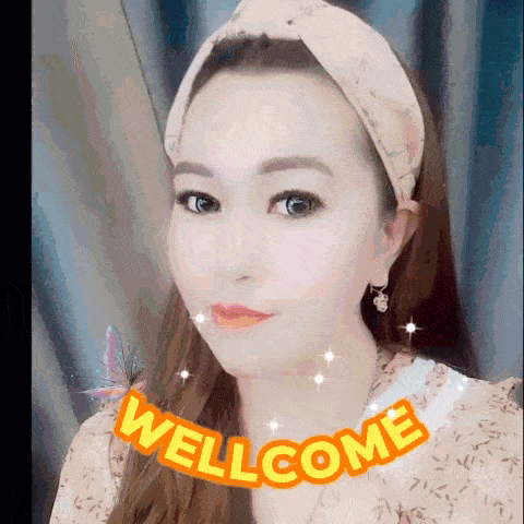 a woman wearing a headband and earrings is surrounded by a welcome sticker .