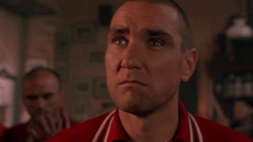 a man in a red shirt has the word " молодец " written on his face