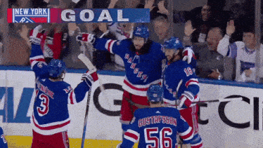 new york rangers hockey players celebrating a goal against the toronto maple leafs