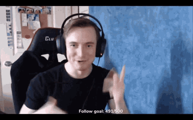 a man wearing headphones with the words follow goal 491/500 above him