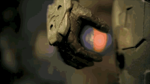 a close up of a person holding a red object in their hand