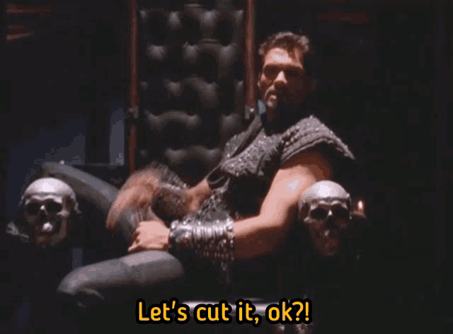 a man is sitting in a chair with skulls and the words let 's cut it ok