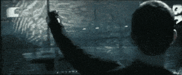 a man is looking at a screen with the letter c on it .