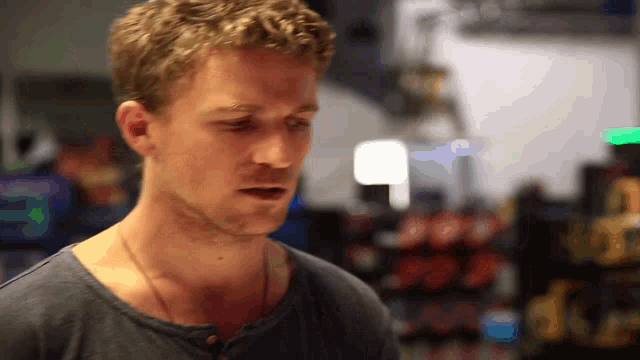 a man with a necklace around his neck looks at something