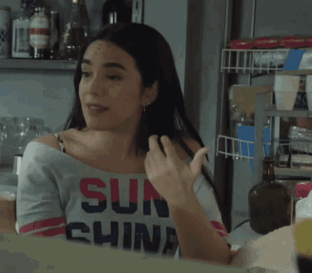 a woman wearing a shirt that says " sun shine "