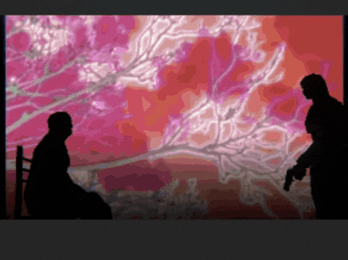 a silhouette of a man sitting in a chair and a man with a gun