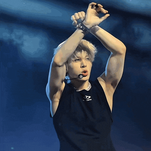 a man wearing a black tank top that says ' x nation ' on it