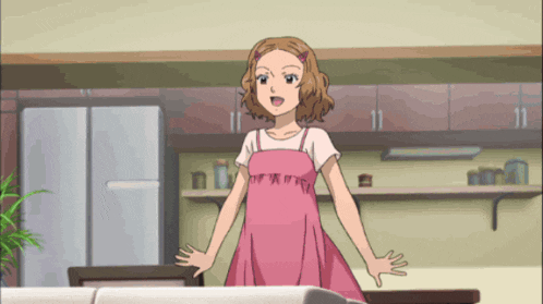 a girl in a pink dress stands in a kitchen
