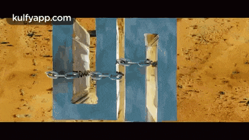 a chain is attached to a piece of wood that looks like a door .