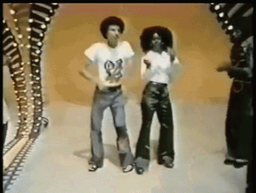 a man and a woman are dancing together and the man has a shirt that says ' snoop dogg ' on it