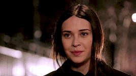 a close up of a woman 's face with a blurred background