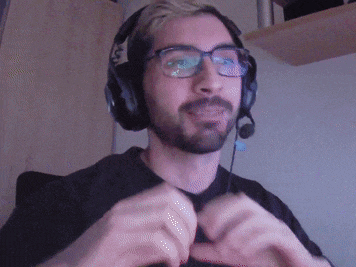 a man with a beard wearing headphones and a microphone is making a heart shape with his hands