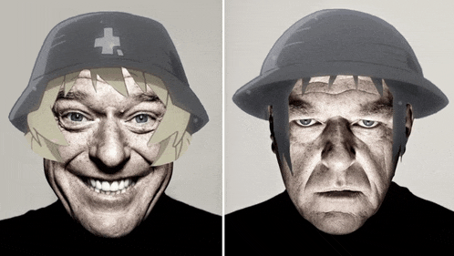 a man wearing a helmet with a cross on it smiles next to another man wearing a helmet with a cross on it