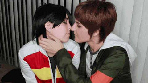 a man and a woman are kissing each other
