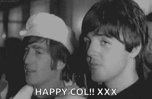 a black and white photo of two men standing next to each other with the words `` happy col ! xxx '' written on the bottom .