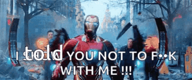 iron man is standing in the middle of a city and says i told you not to f k with me .