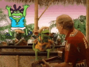 a man is standing in front of a group of muppets .