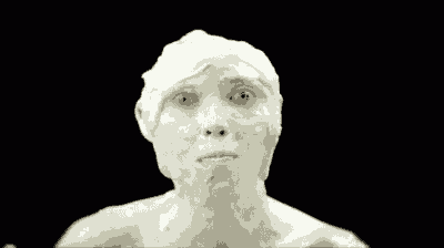 a statue of a man with a spoon in his mouth and foam on his face .