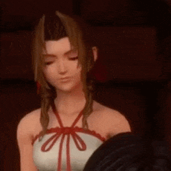 a close up of a cartoon character in a white top with a red bow .