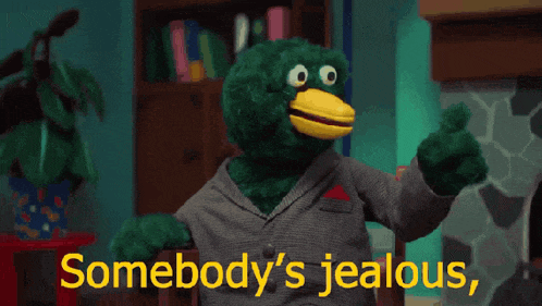 a stuffed animal giving a thumbs up with the words somebody 's jealous behind it