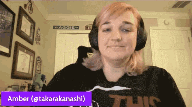 a woman wearing headphones and a shirt that says this is named amber