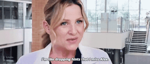 a woman in a lab coat is talking in a hospital room .