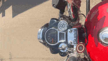 a red motorcycle has a gauge that says gumi