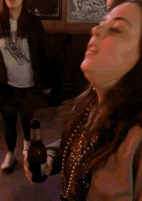 a woman in a sweatshirt with a skull on it is dancing