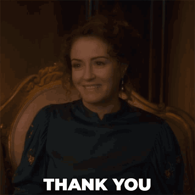 a woman sitting in a chair with the words thank you written below her