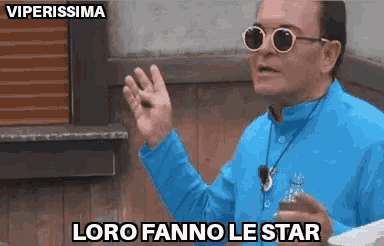 a man wearing sunglasses and a blue jacket says " loro fanno le star "