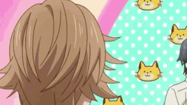a close up of a person 's hair with a pattern of cats on a pink and green background .