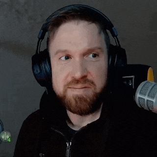 a man with a beard wearing headphones and a microphone