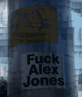 a sign that says fuck alex jones on a building