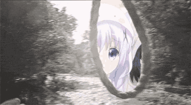 a girl with blue eyes is looking out of a hole in the ground