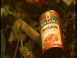 a can of boyardee beefaroni sits on a pile of vegetables