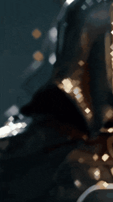 a close up of a skeleton wearing a black hood