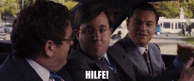 three men in suits and ties are sitting in a car and one of them is saying hilfe .