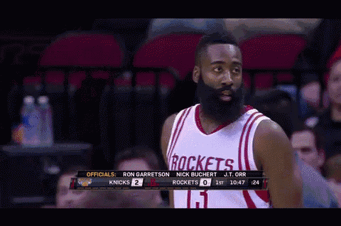 a basketball player wearing a rockets jersey stands in front of a crowd