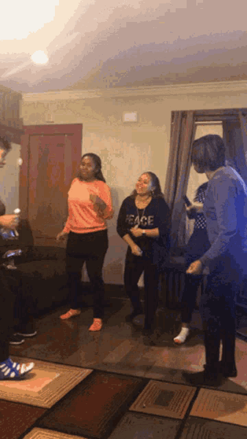 a woman wearing a peace shirt is dancing