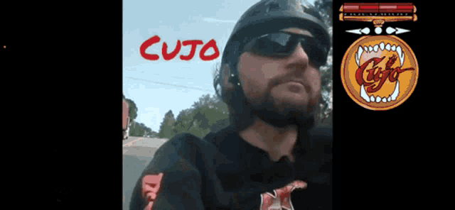 a man wearing sunglasses and a helmet with cujo written on the top